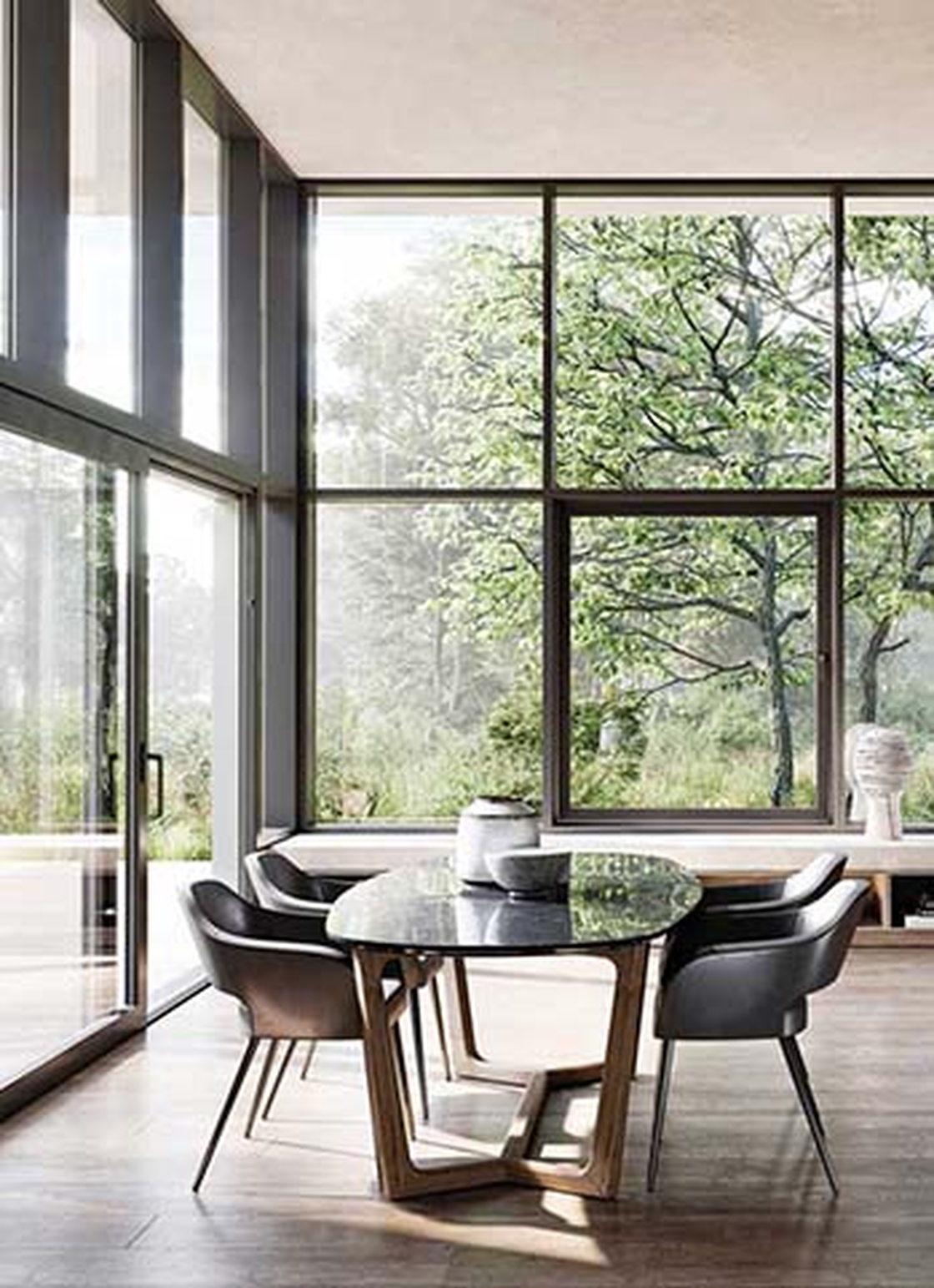 Essbereich mit raumhohen Glasfronten und Blick in den Garten