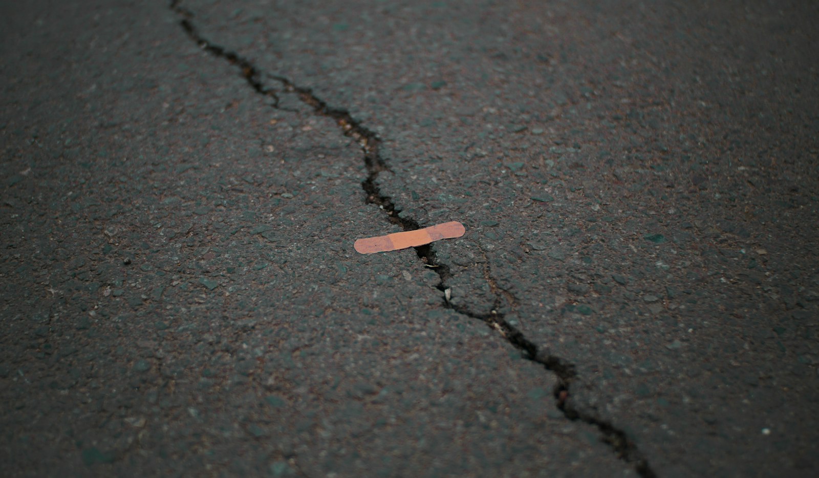 Riss im Asphalt mit einem Pflaster