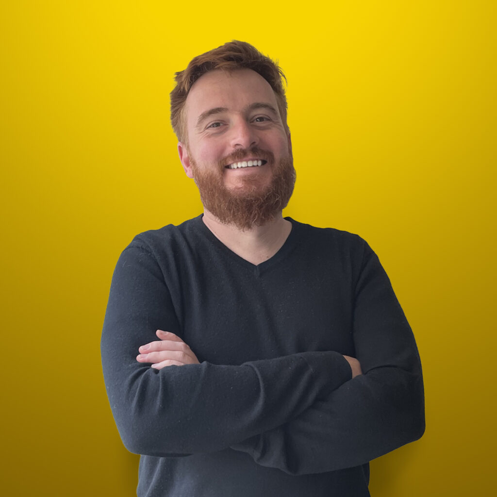 Porträt von Michael, einem loyalen Freund, der lächelt und in einem gemütlichen Café sitzt